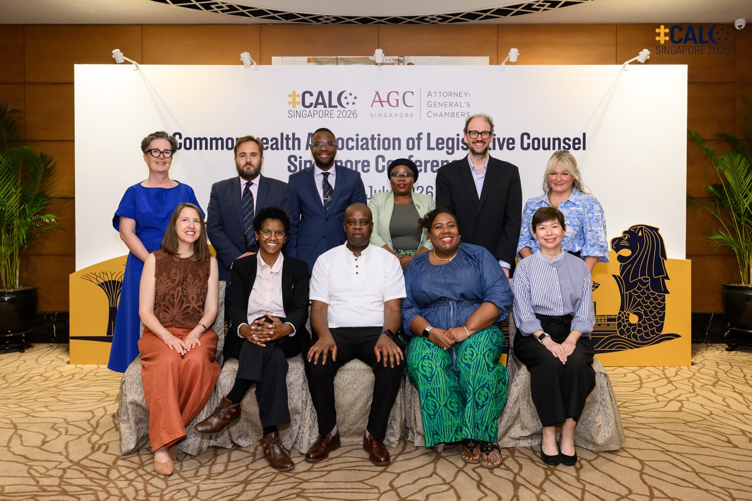 The outgoing CALC Council posed in front of the Conference backdrop at The Fullerton Hotel Singapore.